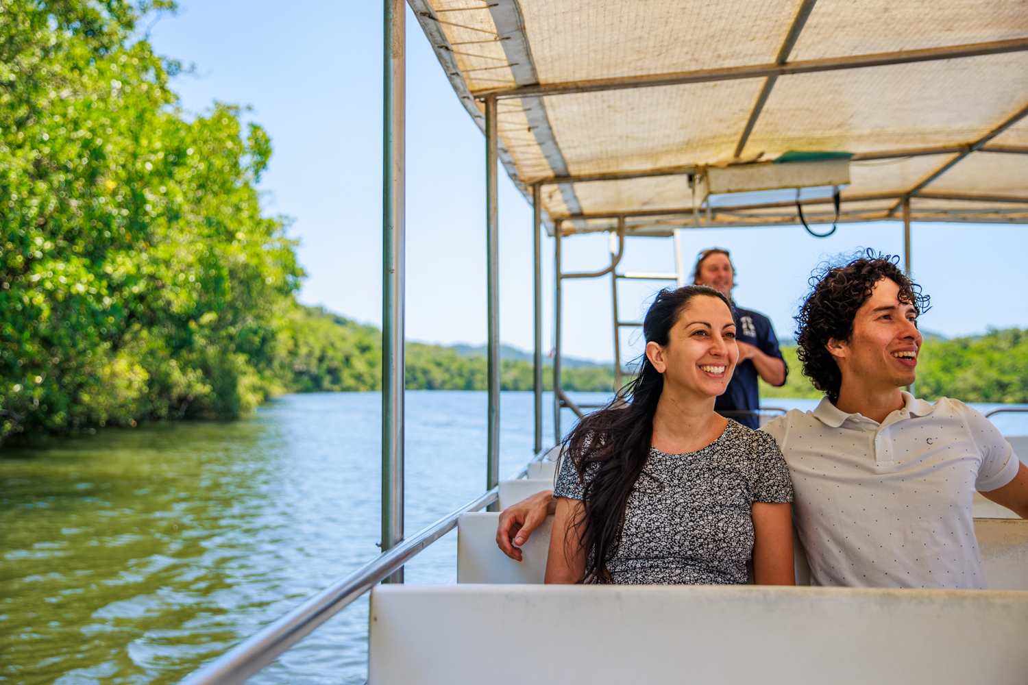 a couple smiling whilst relaxing on a Daintree River Cruise Boat