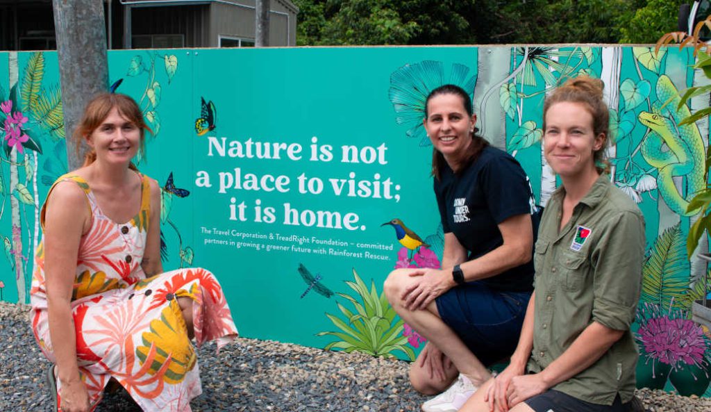 Victoria McGrane (The Scenic Route), Erin Simpson (Down Under Tours) and Marine Deliens (Rainforest Rescue) in front of the new mural at Rainforest Rescue Native Nursery