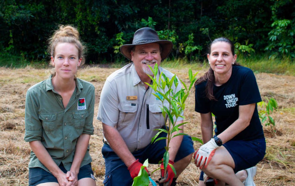 Marine Deliens (Rainforest Rescue), Joe Ahie (Down Under Tours) and Erin Simpson (Down Under Tours) planting trees in partnership